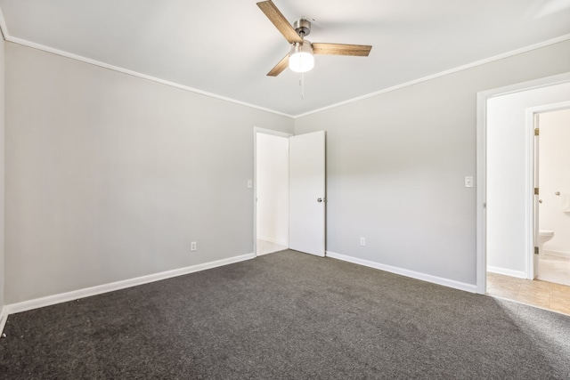 carpeted empty room featuring ceiling fan and crown molding