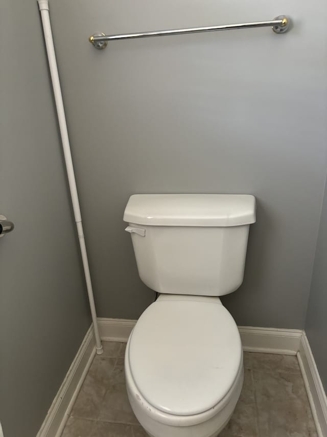 bathroom with toilet and tile patterned flooring