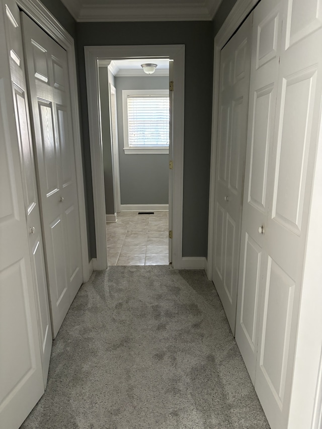 hall featuring light carpet and ornamental molding