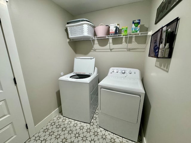 laundry room featuring washer and clothes dryer and light tile patterned floors