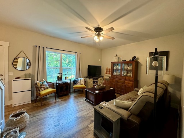 living room featuring hardwood / wood-style floors and ceiling fan