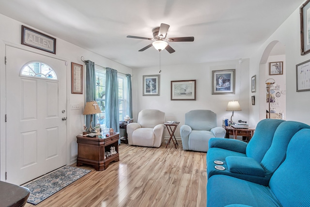 living room featuring light hardwood / wood-style flooring and ceiling fan