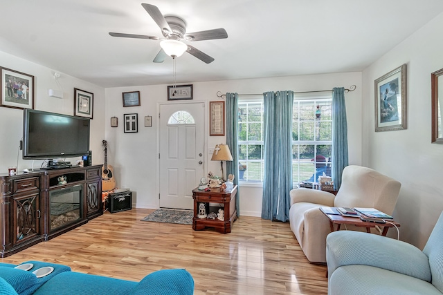 living room with light hardwood / wood-style floors and ceiling fan