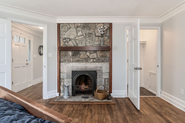 unfurnished living room with a stone fireplace, dark hardwood / wood-style floors, and ornamental molding