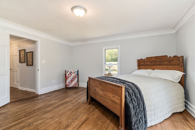 bedroom with crown molding and hardwood / wood-style floors