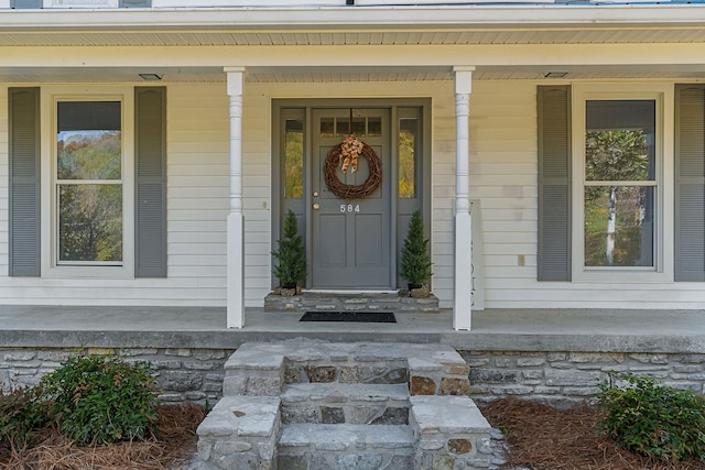 view of exterior entry with a porch