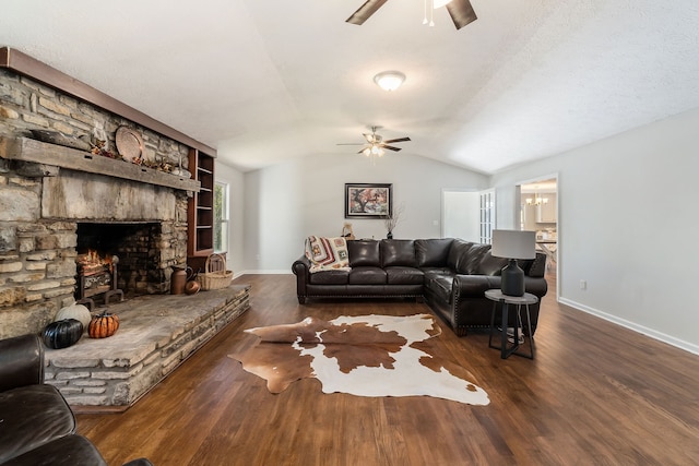 living room with vaulted ceiling, a fireplace, dark hardwood / wood-style floors, and ceiling fan