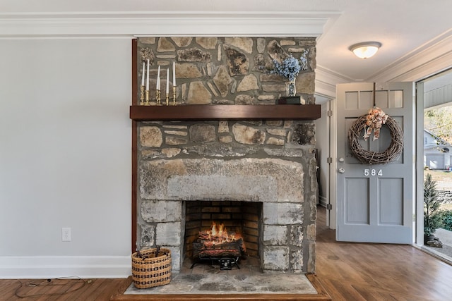 details with a stone fireplace, ornamental molding, and hardwood / wood-style flooring