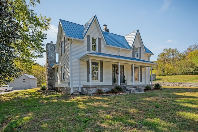 view of front of property with a front lawn, an outbuilding, and a porch