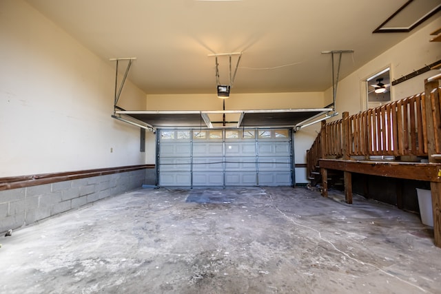 garage with ceiling fan and a garage door opener