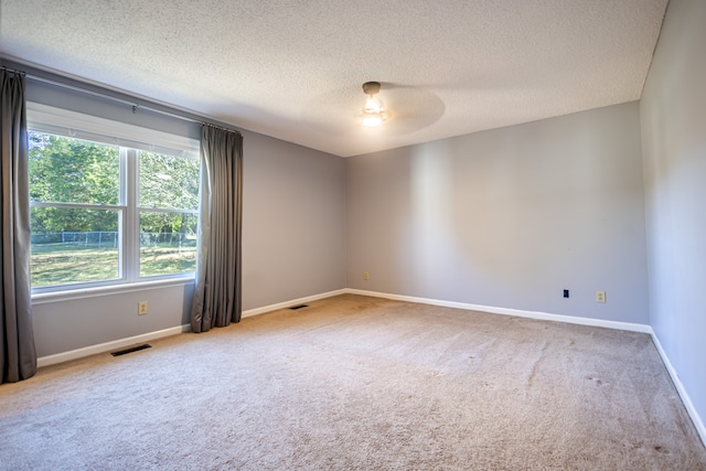 carpeted empty room with a textured ceiling and ceiling fan