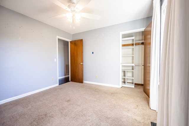 unfurnished bedroom with a closet, ceiling fan, and light colored carpet