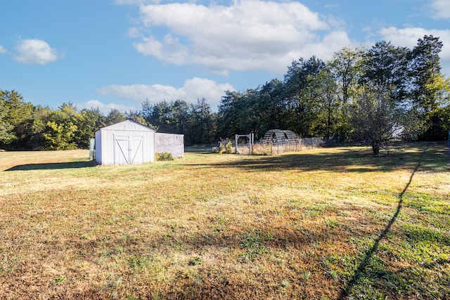 view of yard with a storage unit and a rural view