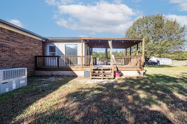 view of yard with central AC and a deck