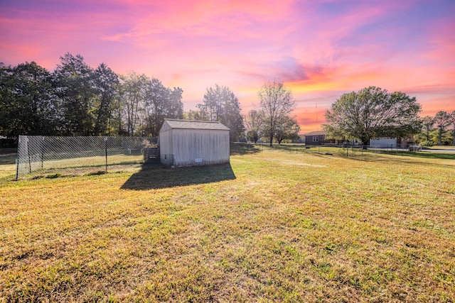 yard at dusk with a storage shed