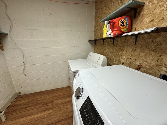 laundry room featuring independent washer and dryer and hardwood / wood-style floors