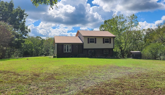 tri-level home featuring a storage unit and a front lawn