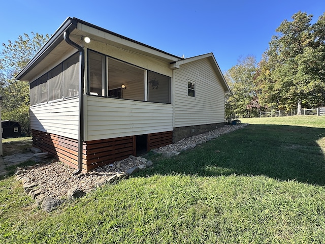 view of home's exterior with a lawn