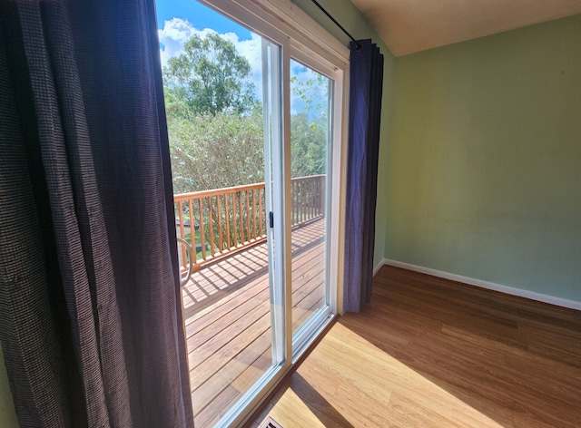 doorway with hardwood / wood-style flooring