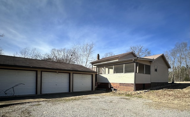 exterior space with an outdoor structure and a garage