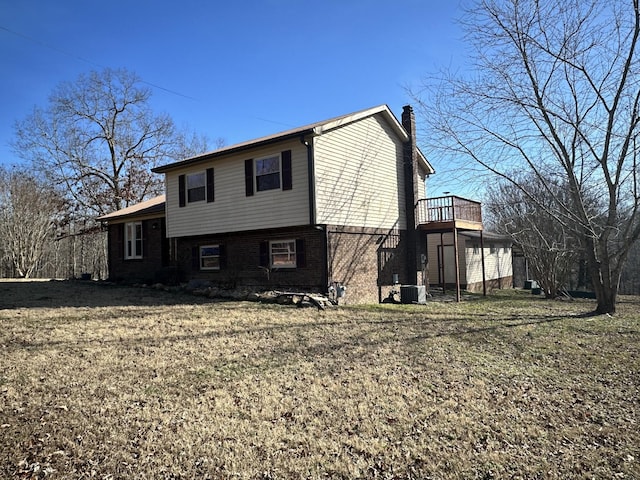 exterior space with a lawn and central air condition unit