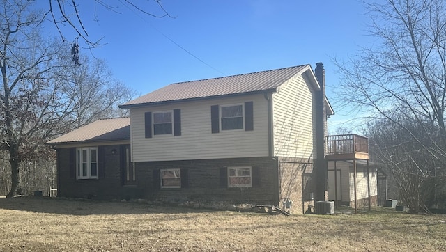 view of front of house with a balcony and central AC