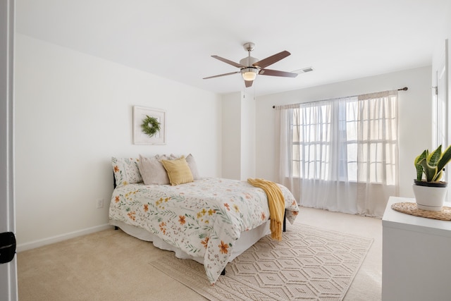 bedroom with light carpet and ceiling fan