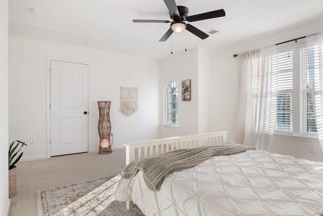 carpeted bedroom with multiple windows and ceiling fan