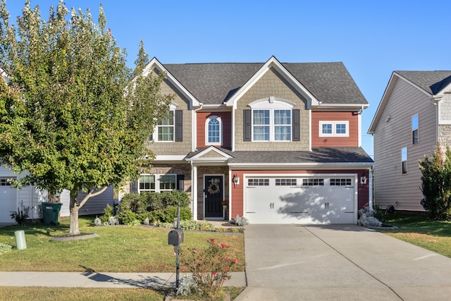 view of front of home featuring a front yard and a garage