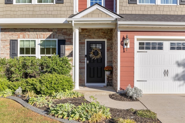 doorway to property with a garage