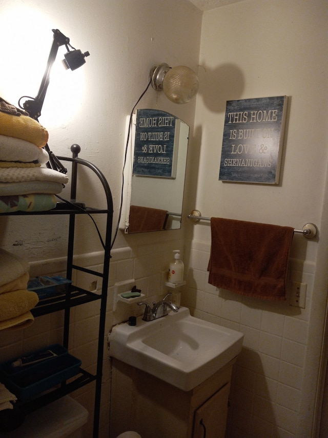 bathroom featuring vanity, tile walls, and decorative backsplash