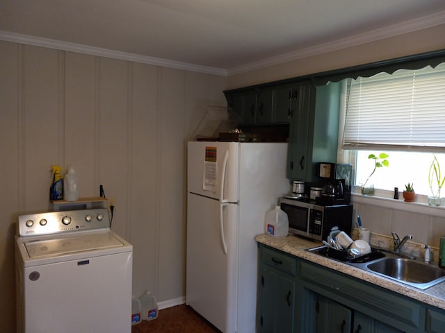 kitchen featuring washer / dryer, ornamental molding, white fridge, and sink