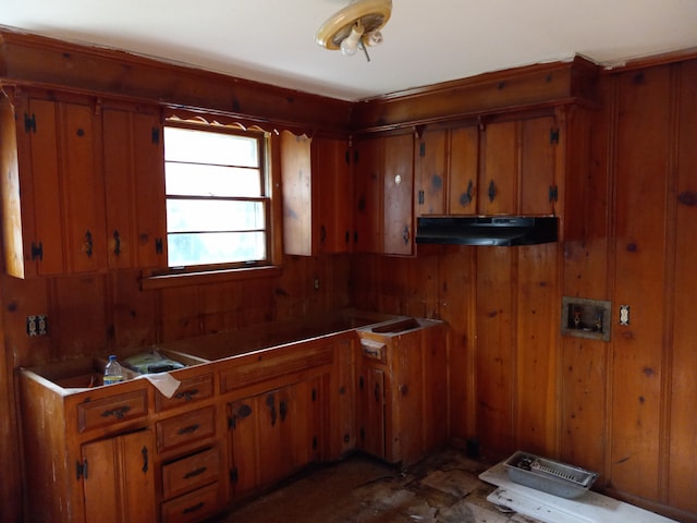 kitchen featuring wood walls