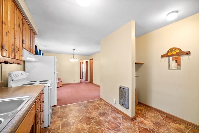 kitchen with white range, sink, carpet, pendant lighting, and heating unit