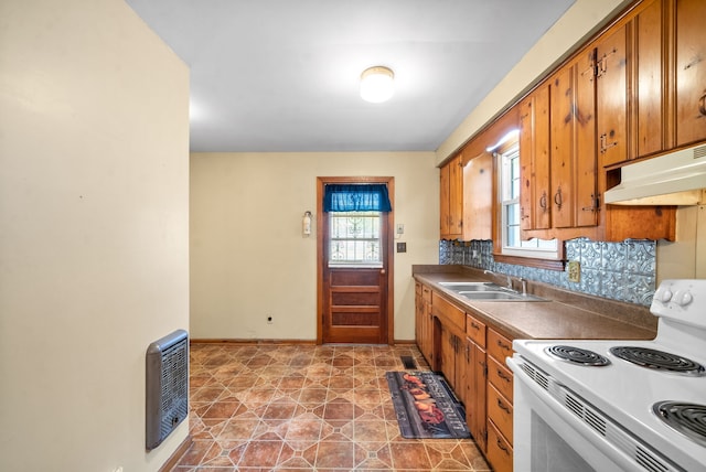 kitchen with electric stove, heating unit, decorative backsplash, and sink