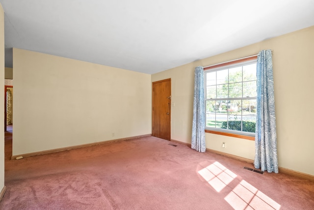 unfurnished room with light colored carpet