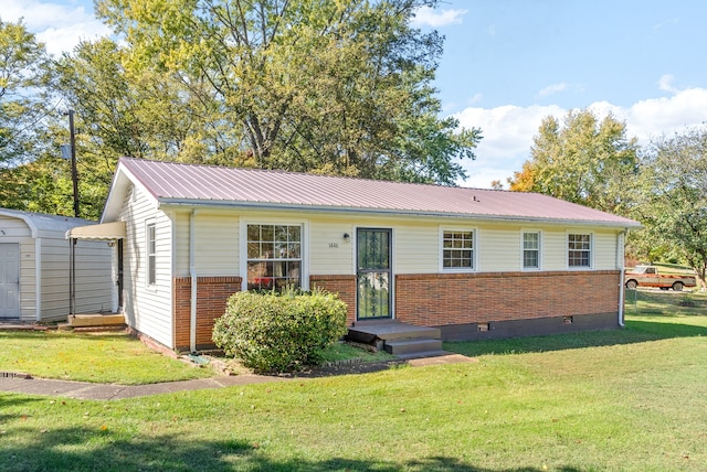 view of front facade with a storage unit and a front yard