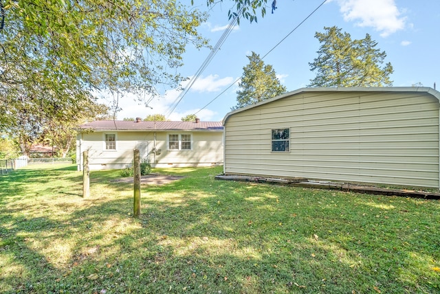 rear view of property with a yard