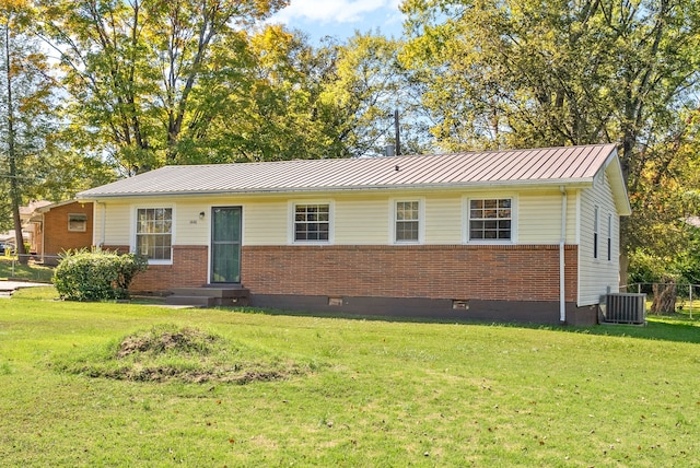 ranch-style house featuring a front lawn and central air condition unit