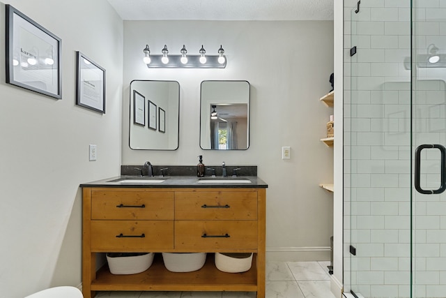 bathroom featuring vanity, toilet, a textured ceiling, and a shower with shower door