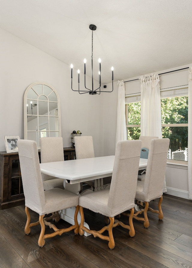 dining room with a chandelier and dark hardwood / wood-style flooring