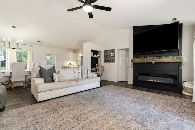 living room featuring lofted ceiling, ceiling fan with notable chandelier, and dark hardwood / wood-style flooring