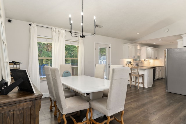 dining area with sink, lofted ceiling, a chandelier, and dark hardwood / wood-style flooring