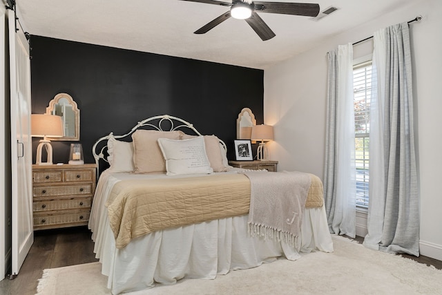 bedroom with dark wood-type flooring and ceiling fan