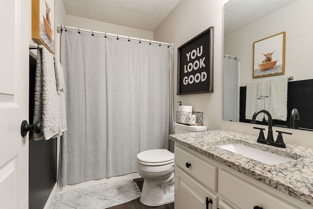 bathroom featuring a textured ceiling, toilet, a shower with curtain, vanity, and hardwood / wood-style flooring