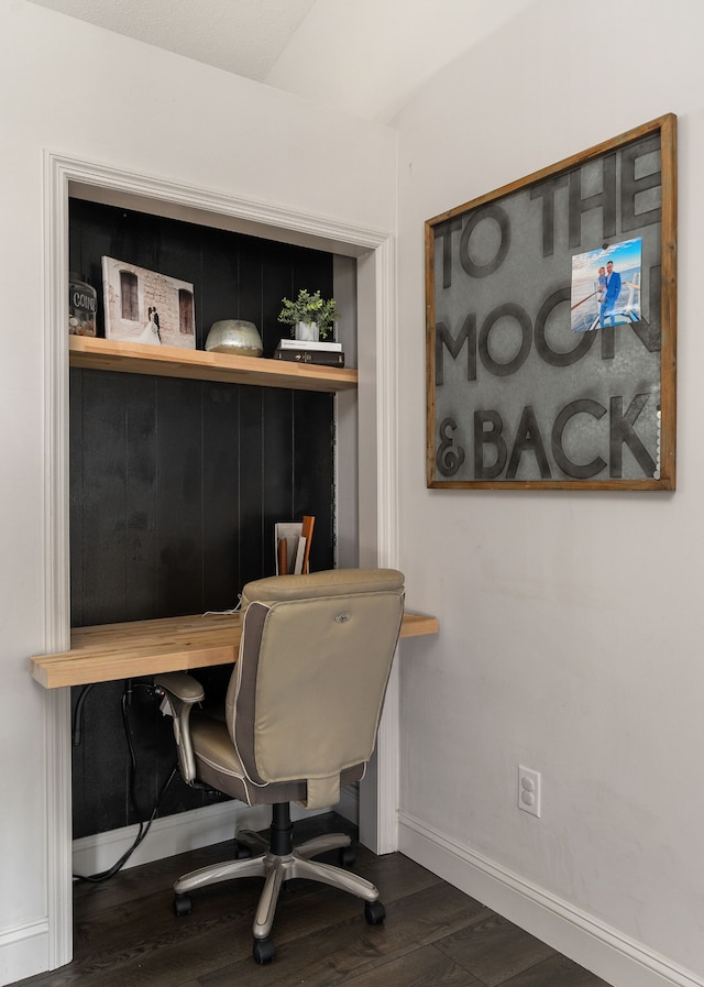 home office with dark hardwood / wood-style flooring