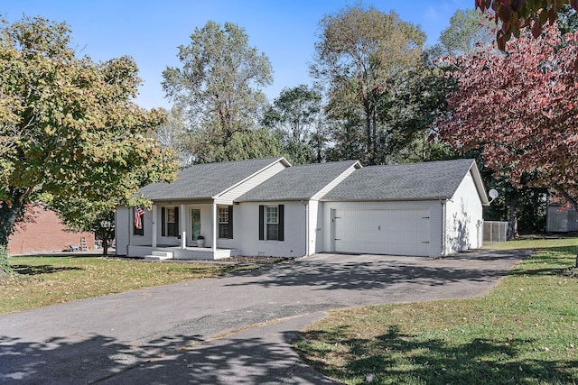 ranch-style house featuring a garage and a front lawn