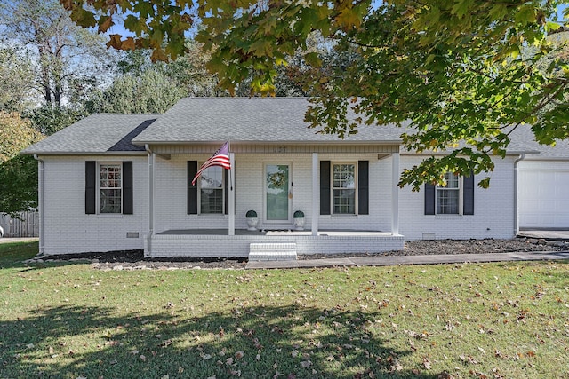 view of front of property with a porch, a front lawn, and a garage