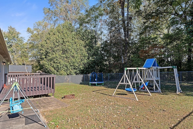 view of yard with a trampoline and a playground