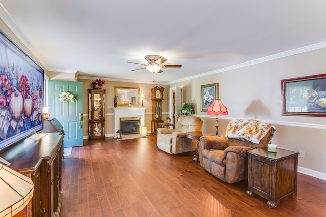 living room with ornamental molding, ceiling fan, and dark hardwood / wood-style flooring